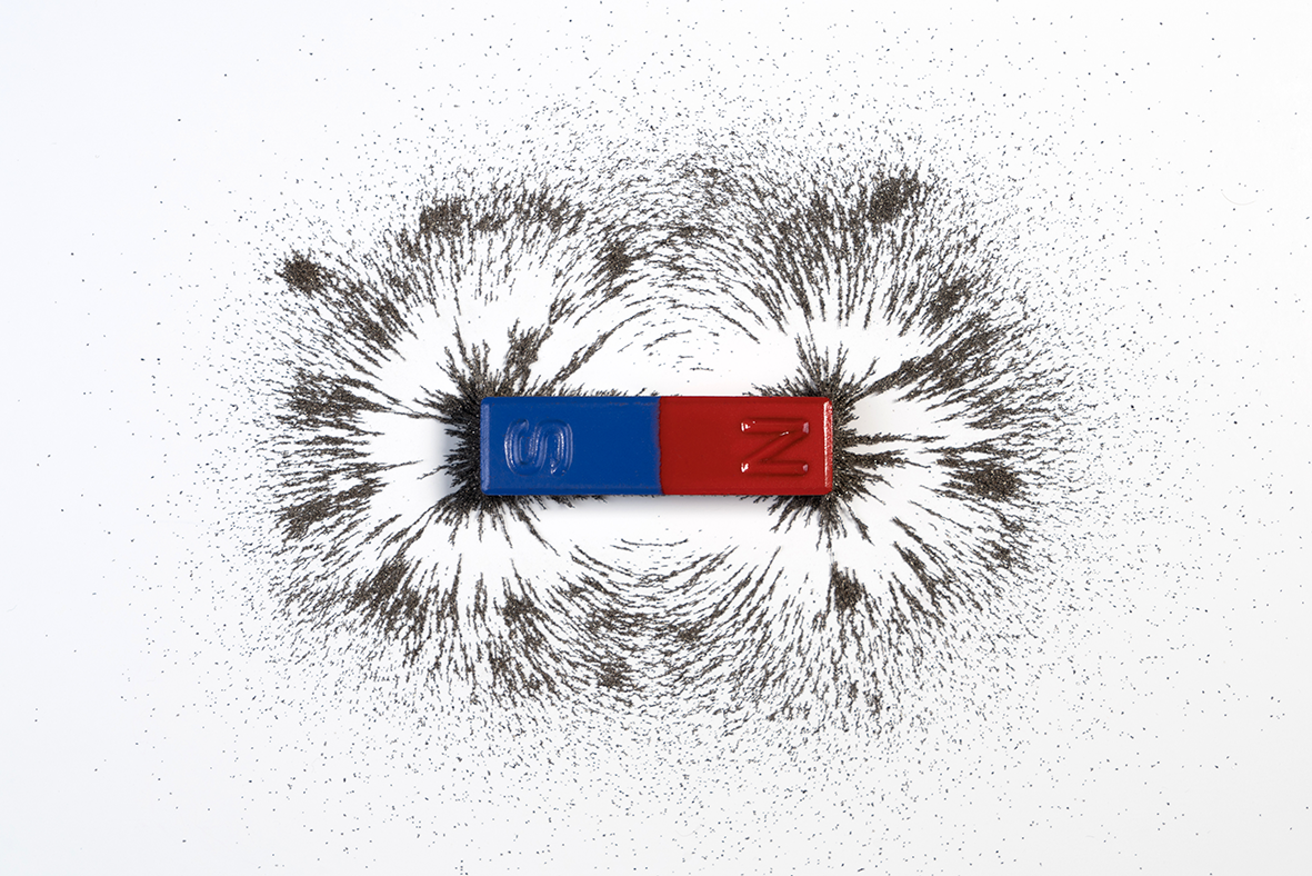Bar magnet with iron filings showing magnetic field